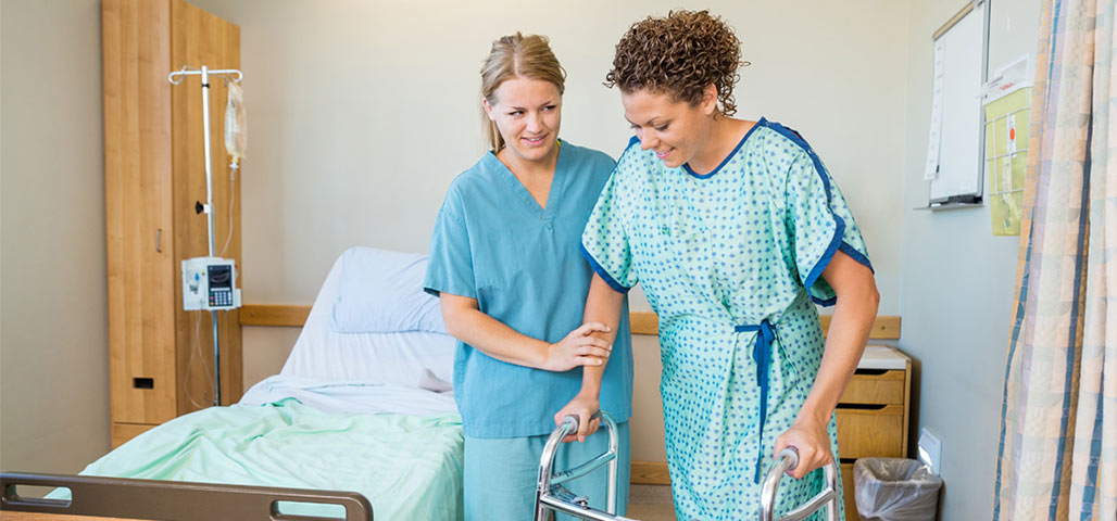 Aide helping patient walk.